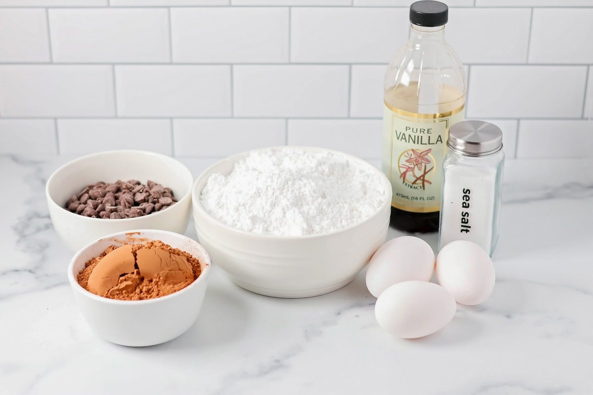 Ingredients for flourless chocolate cookies on a kitchen counter.