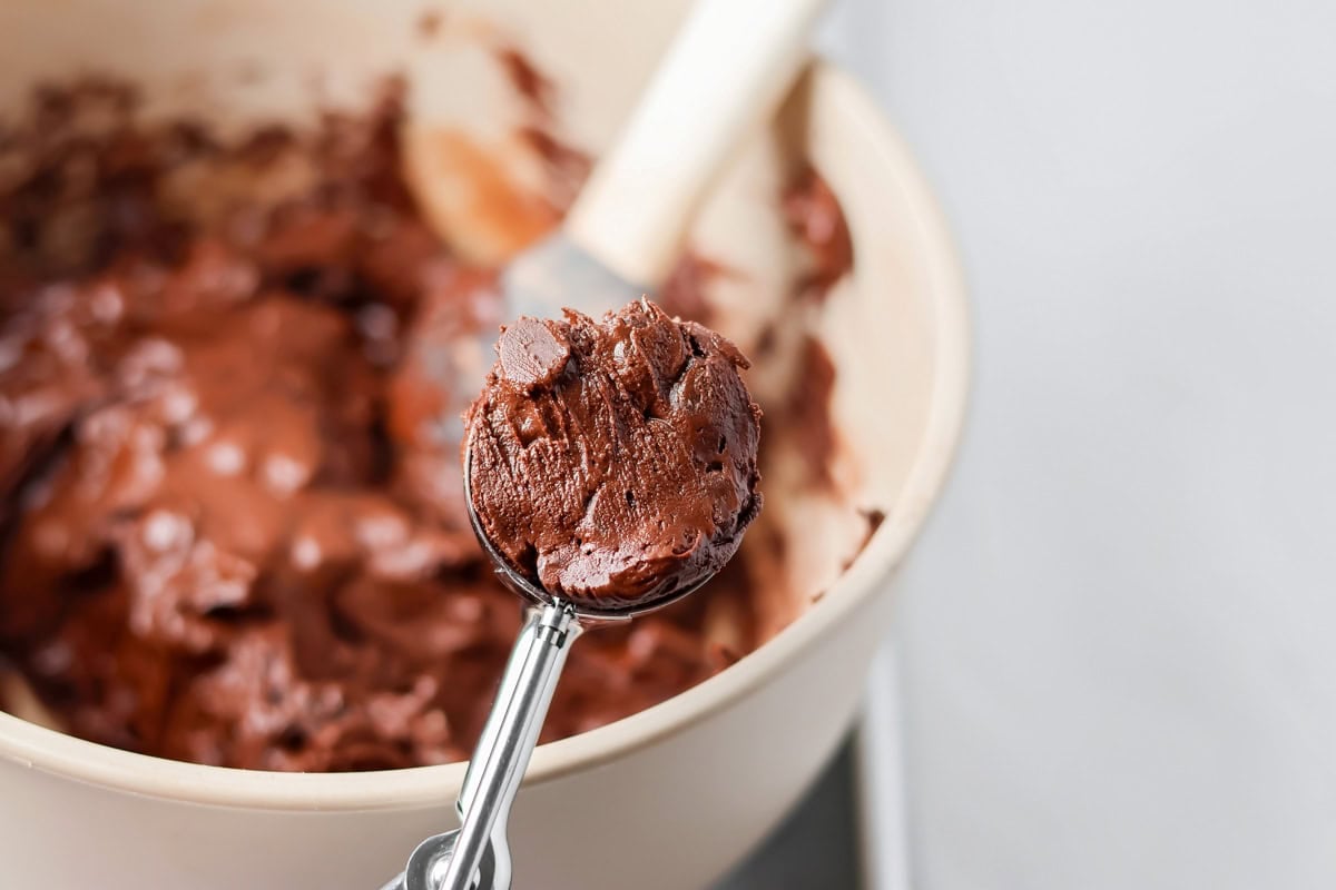 Scooping batter from the bowl.