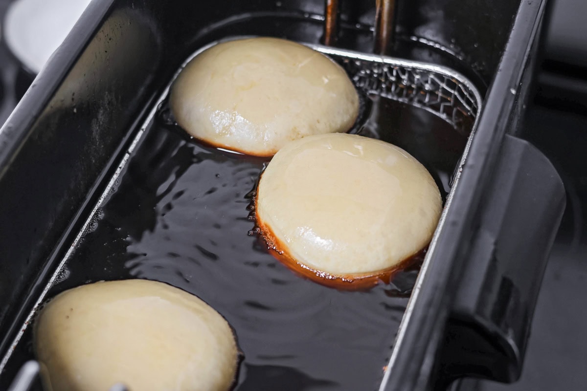 Frying donuts in oil.