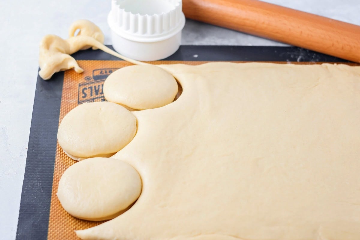 Cutting circles from the rolled dough.