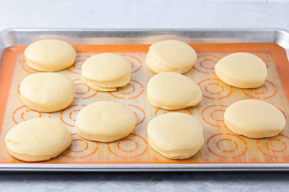Circles of dough on a silpat lined baking sheet.