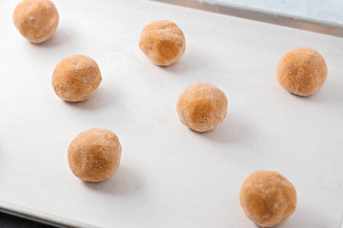 Dipped pumpkin batter balls ready to be baked.