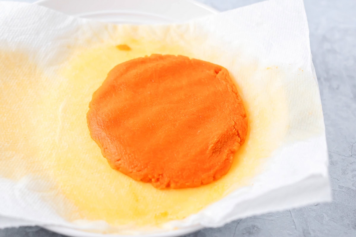 Draining liquid from pumpkin filling.