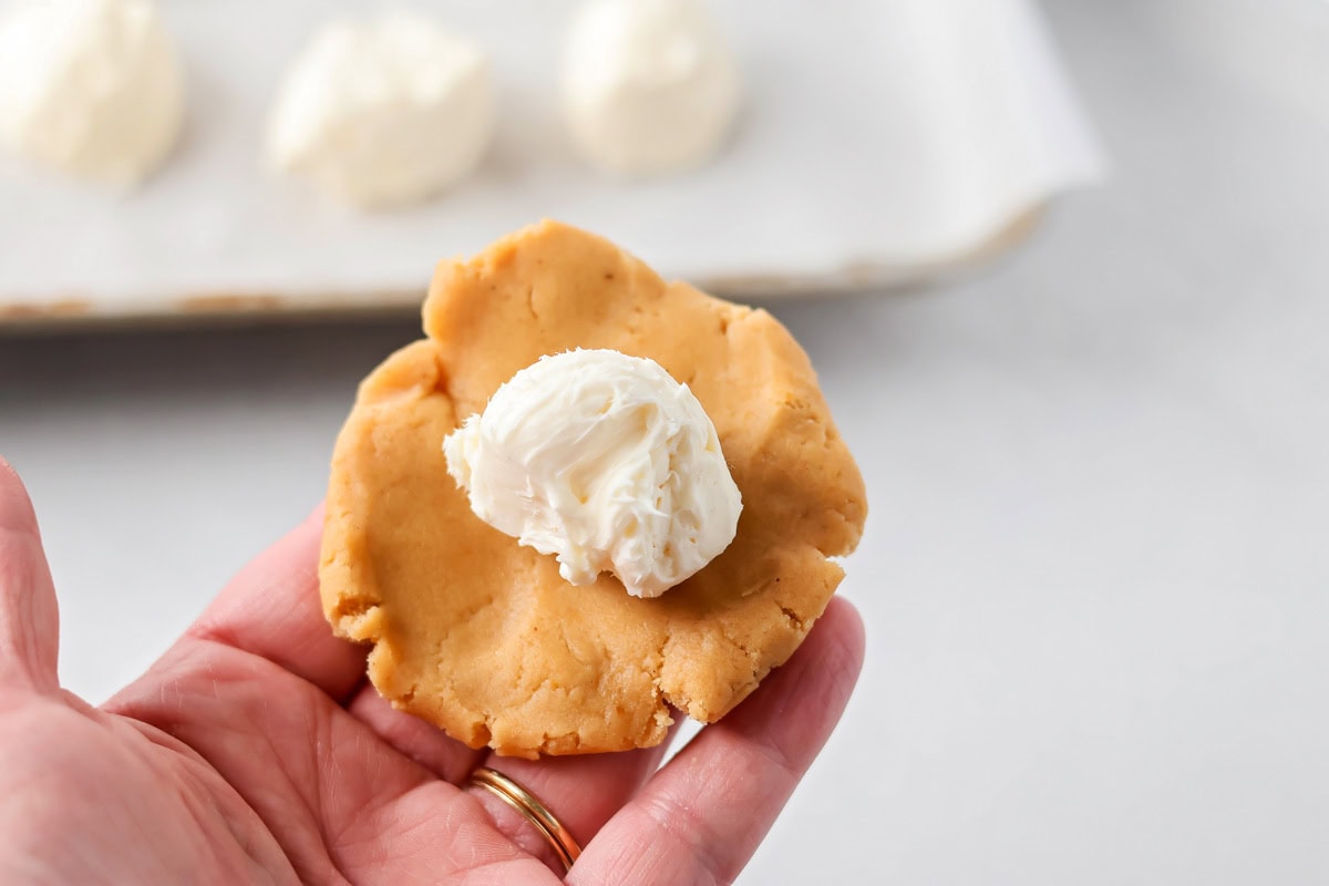 Placing frozen cream cheese filling into the pumpkin batter.