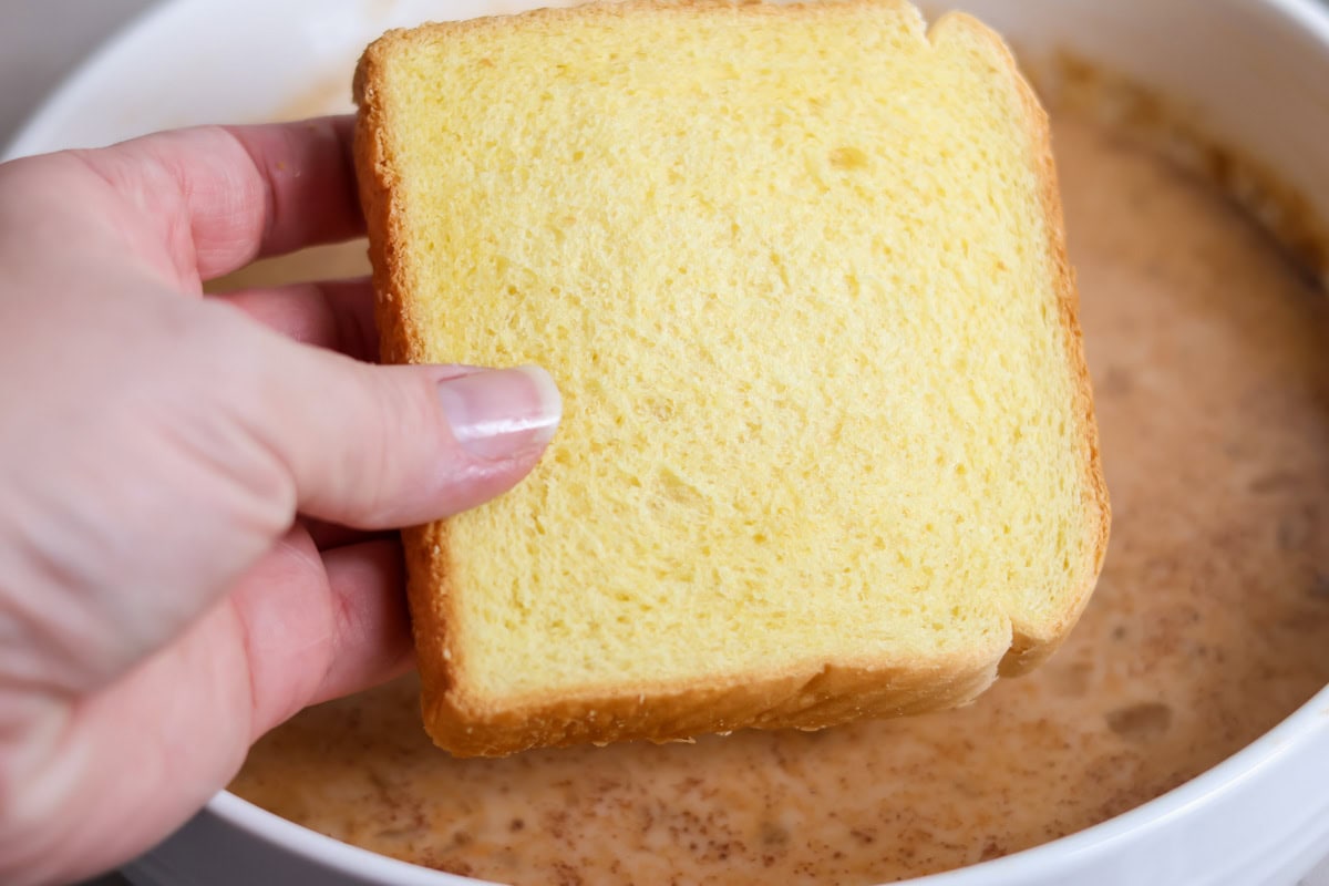 Infused with warm spices and pumpkin, this quick and easy pumpkin French toast transforms breakfast into a cozy, decadent fall favorite! Dipping bread into a bowl of milk, egg mixutre.