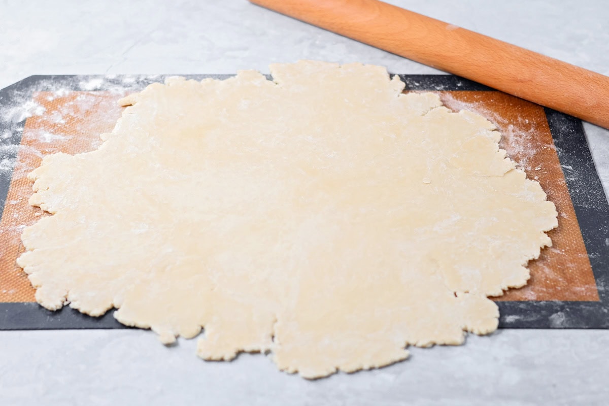 Sour cream apple pie elevates the classic with a rich, tangy, and creamy custard and a buttery crumb topping! Rolled pie crust on a silpat mat.