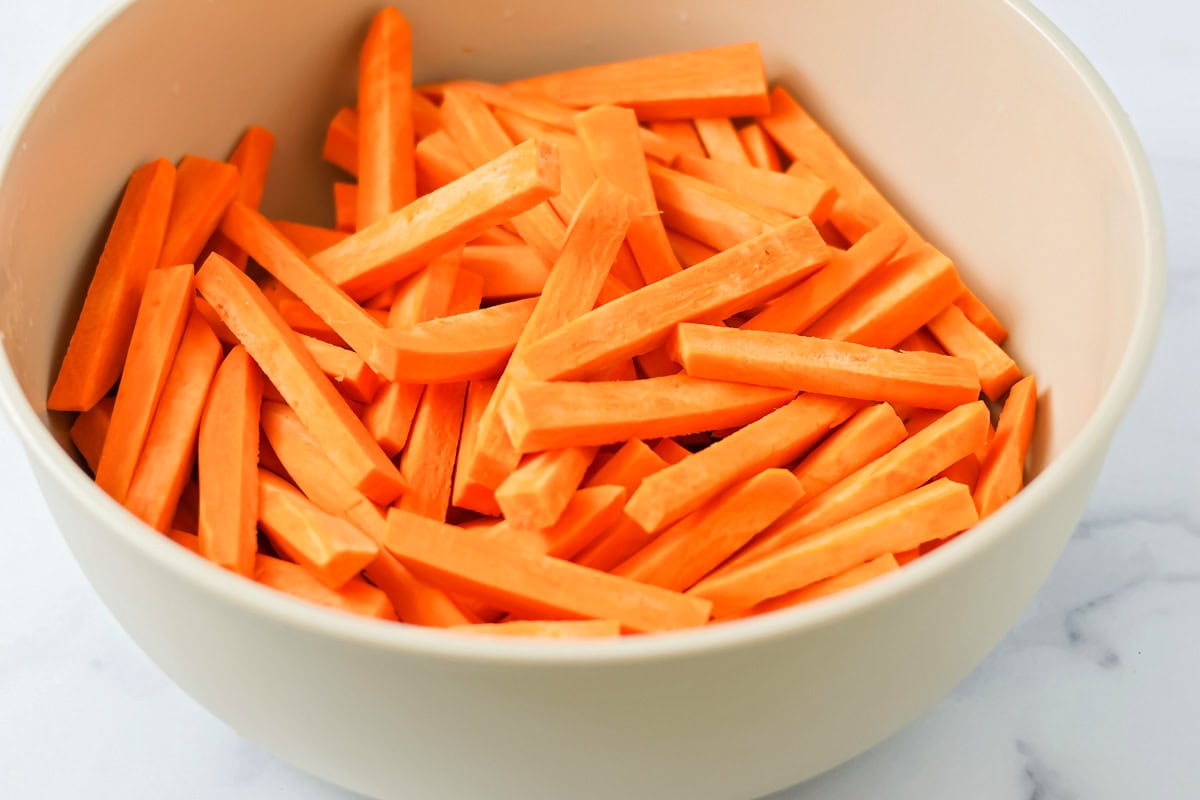 Cut sweet potatoes in a bowl.