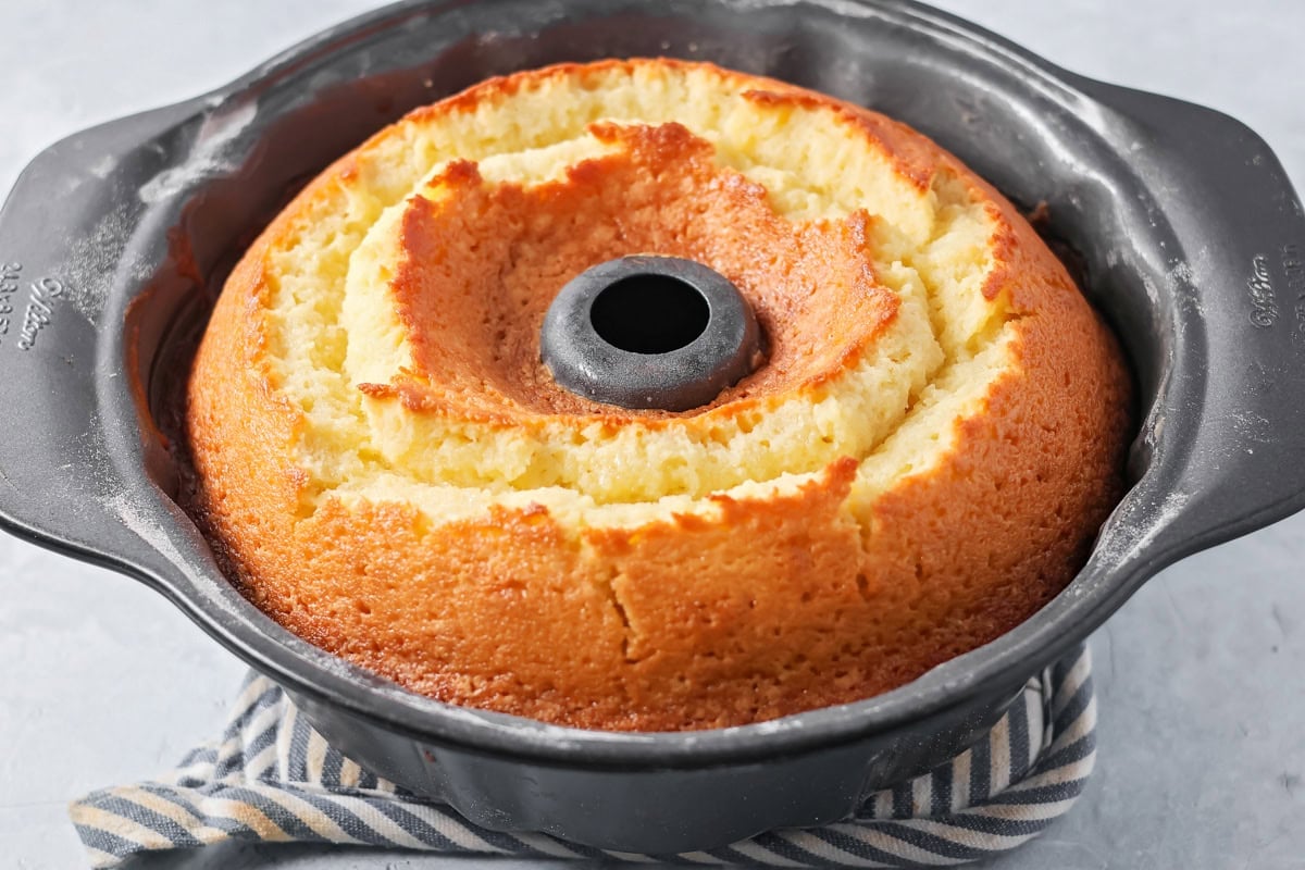 A fully baked cake in a bundt cake pan.
