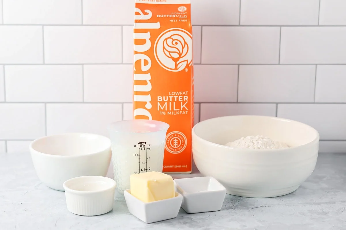 Ingredients to make bonuts on a marble kitchen counter.