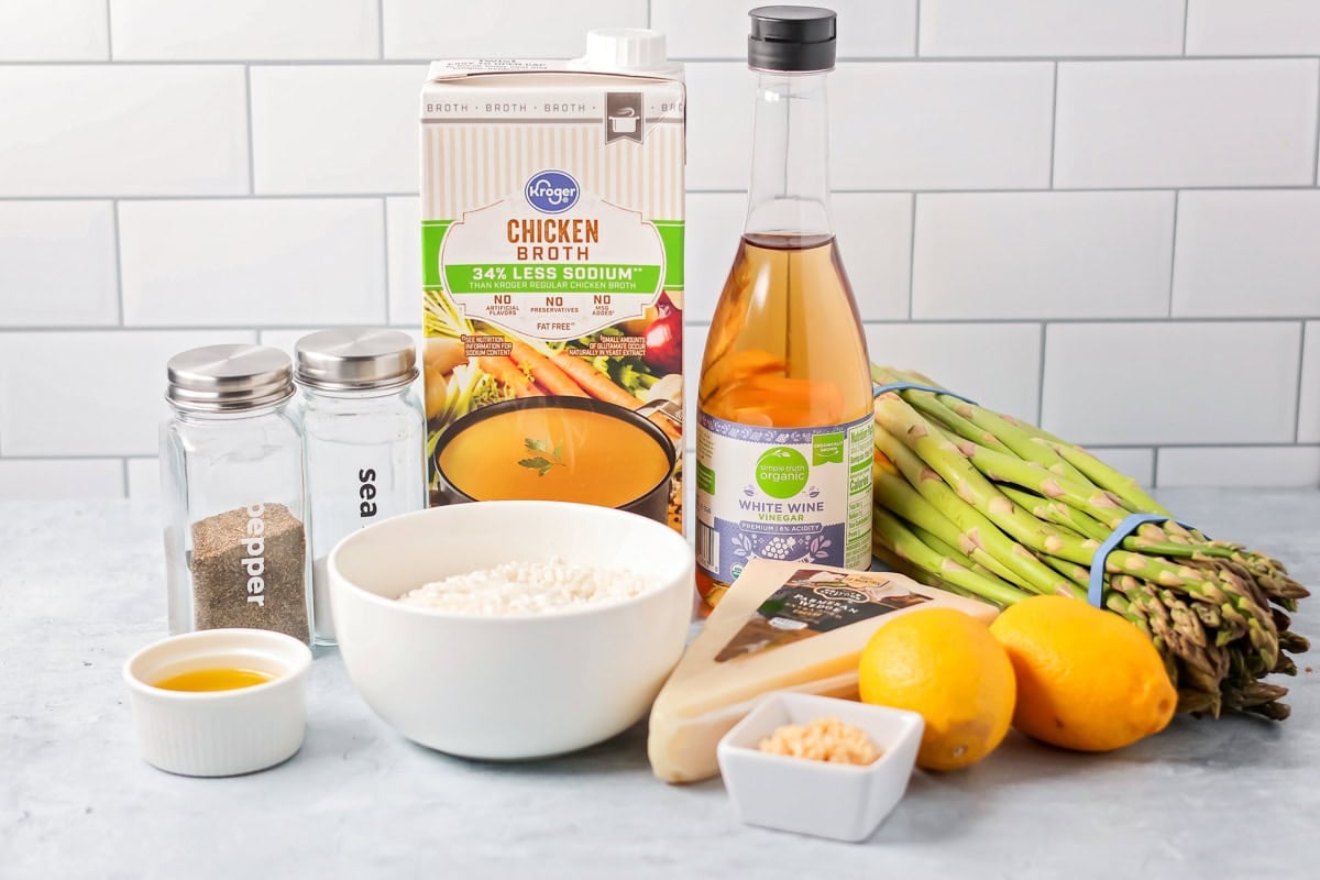 Ingredients for asparagus risotto on a kitchen counter.
