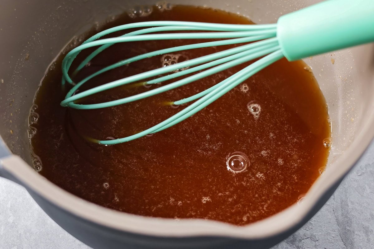 Whisked glaze ingredients in a mixing bowl.