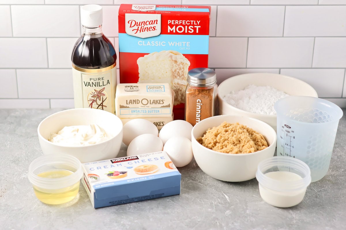 Ingredients to make a cinnamon roll poke cake on a kitchen counter.