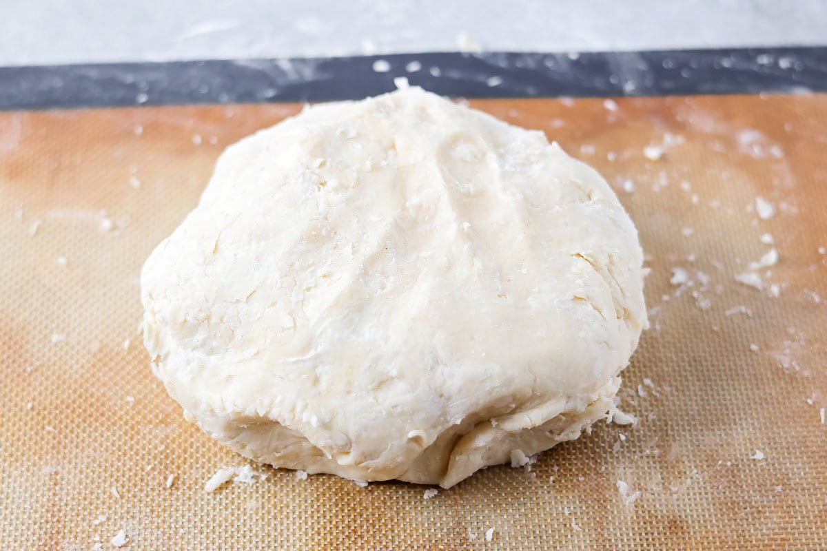 A ball of dough on a rolling mat.