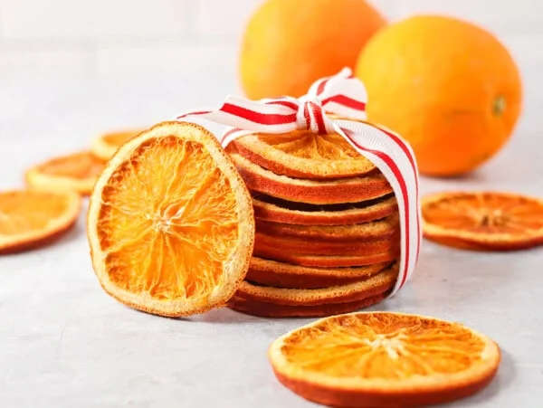 Dried orange slices stacked and wrapped in ribbon.