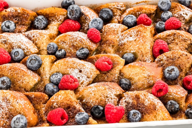 Oven french toast recipe in pan with berries on top.
