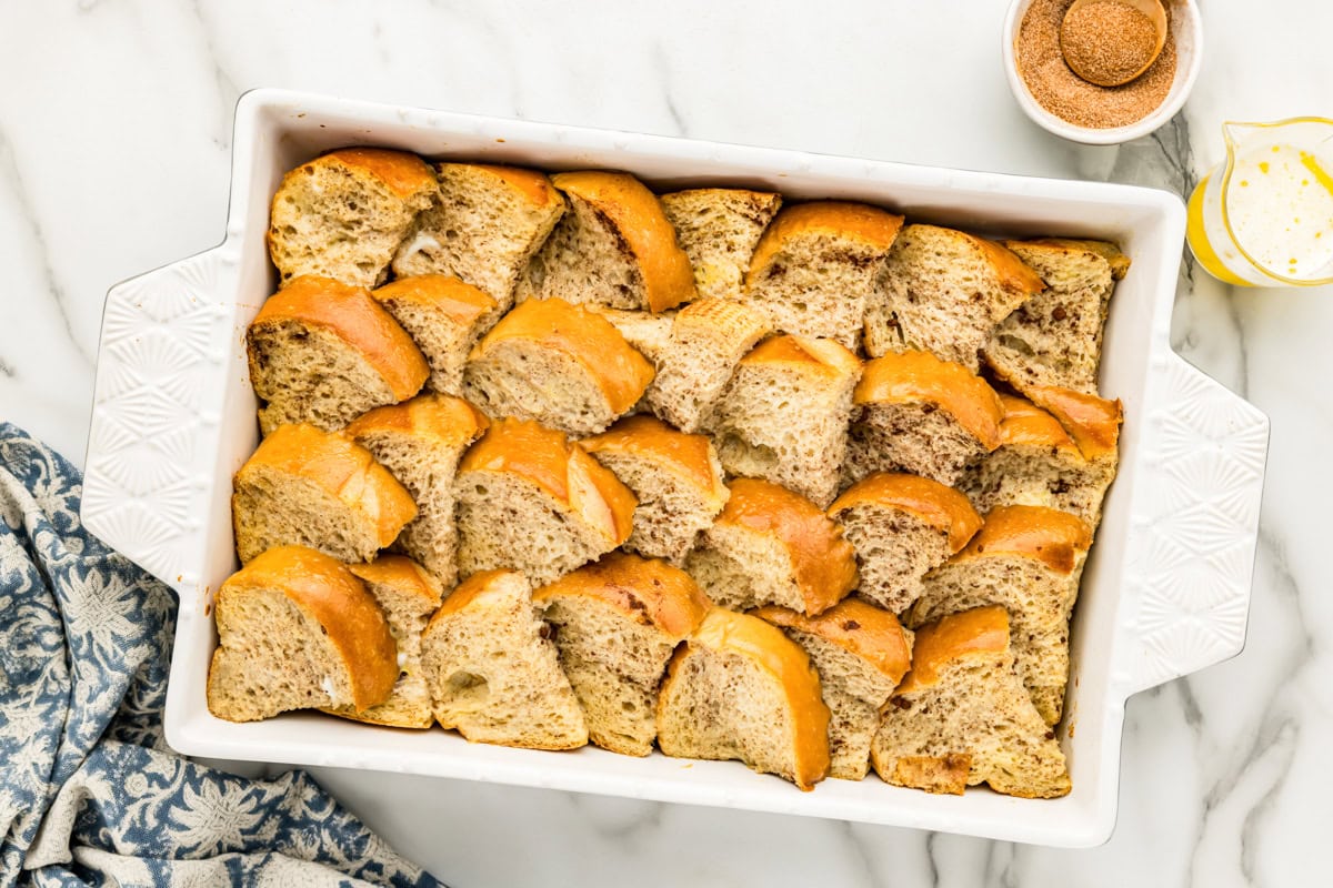 French toast casserole after the remaining egg custard has been poured over it.