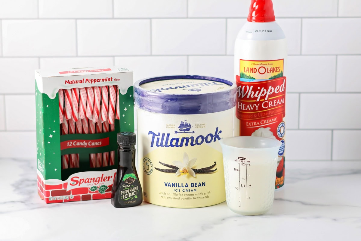 Celebrate the season with this festive peppermint milkshake - it's ready in minutes for a perfect holiday treat! Ingredients to make a peppermint milkshake on a kitchen counter.