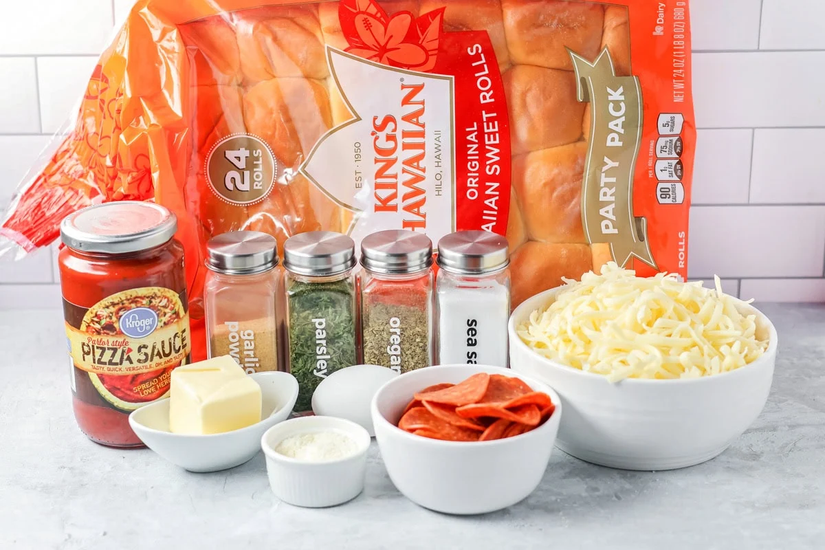 Ingredients to make pizza sliders on a kitchen counter.