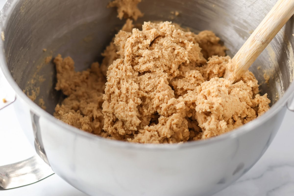 Mixed cookie dough in a mixing bowl.