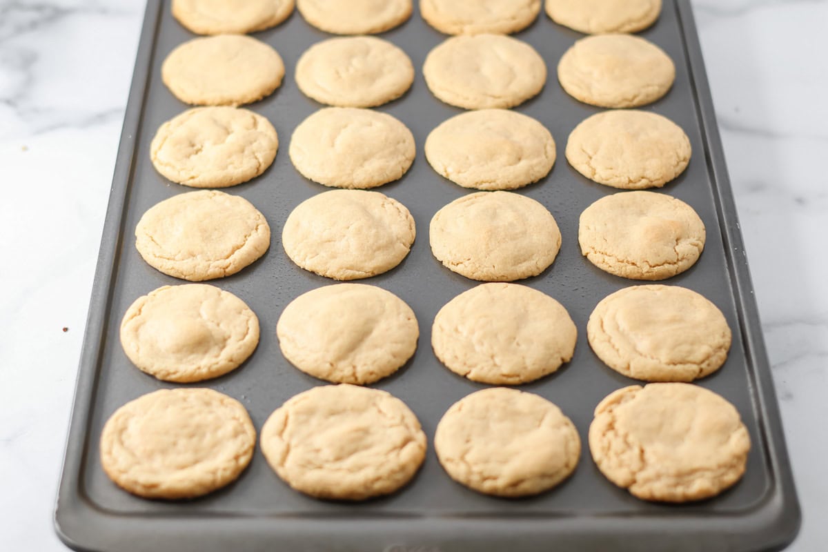 Baked cookie dough balls in a mini muffin pan.