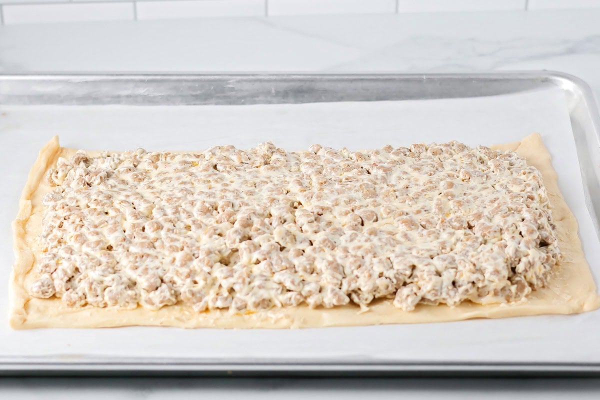 Sausage and cream cheese mixture poured over crescent dough.