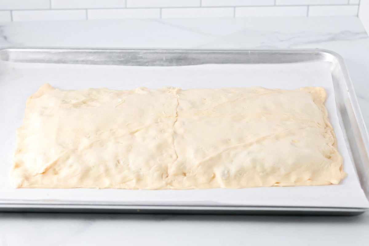 Crescent dough pinched over sausage mixture.