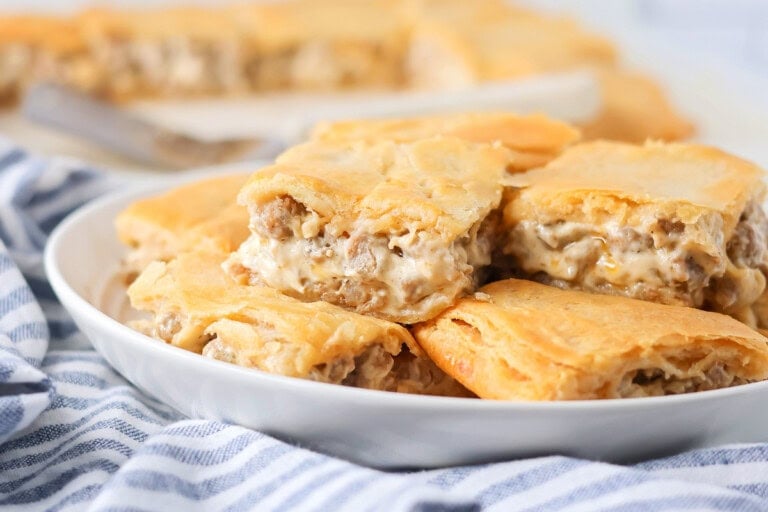 Sausage cream cheese casserole recipe cut and stacked on each other on plate.