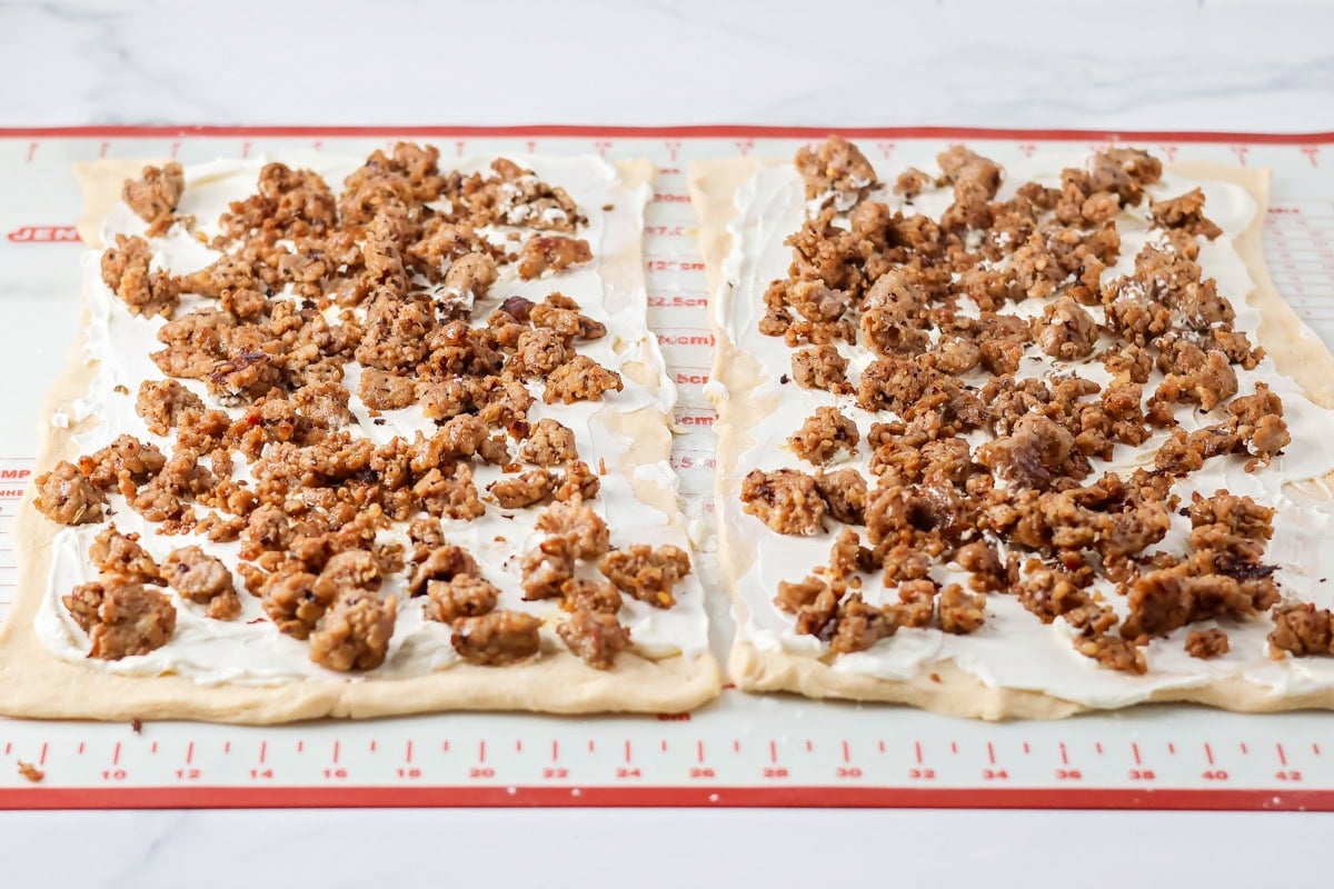Filled with sausage crumbles and cream cheese, these sausage pinwheels are the ultimate savory snack or party appetizer! Crumbles sausage sprinkles over the cream cheese layer.