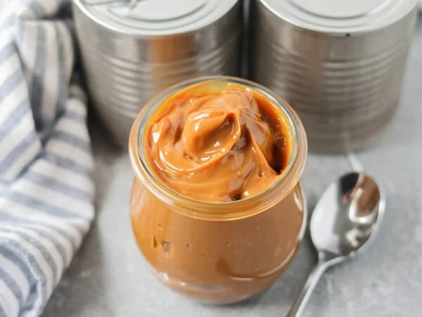 Glass jar with homemade dulce de leche.