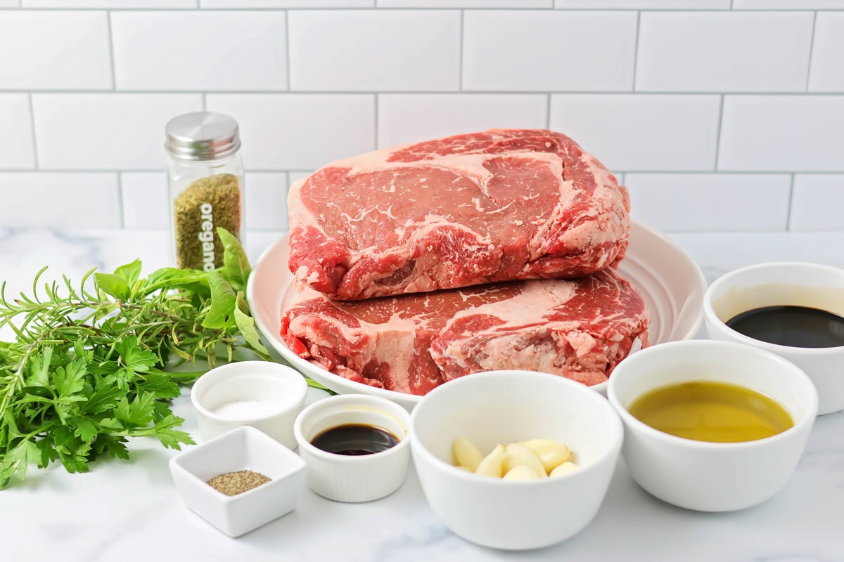Perfect for any occasion, this easy Italian Rib Eye steak recipe brings the fresh flavors of Italy to your kitchen. Ingredients to. make Italian rib eye on a kitchen counter.