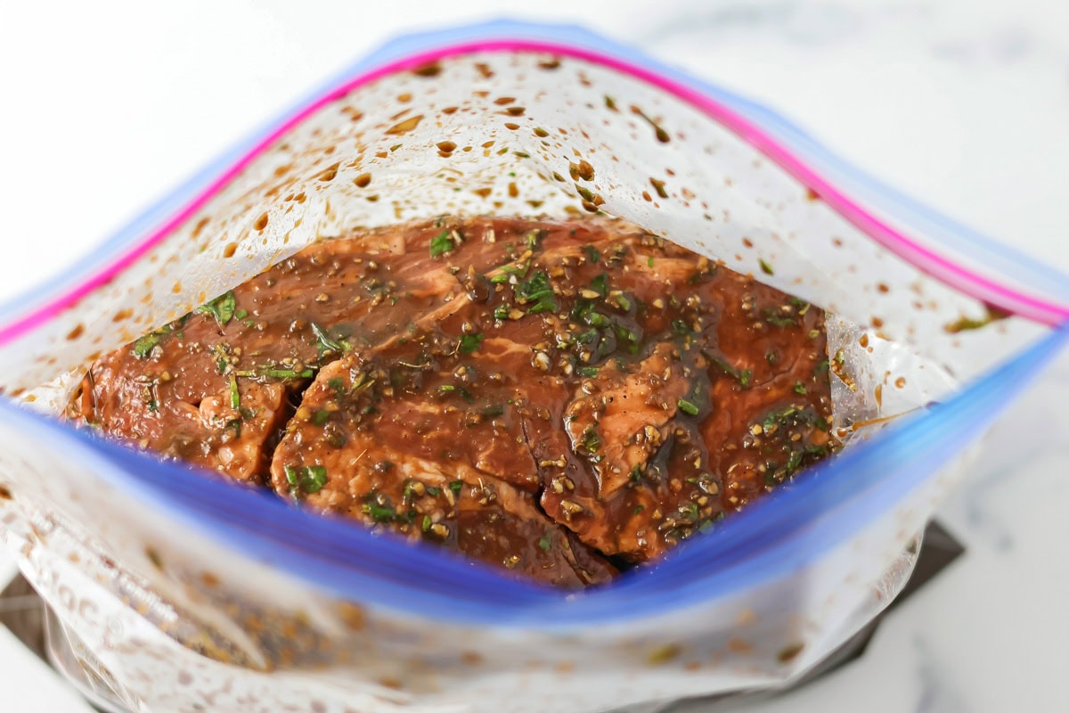 Steak and marinade in a ziplock bag.