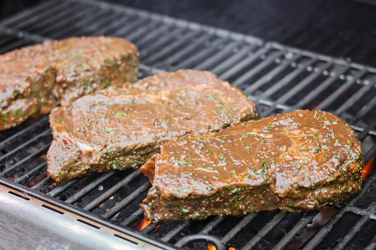 Grilling three Italian steaks.