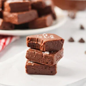 Pieces of homemade nutella fudge stacked on a white plate.