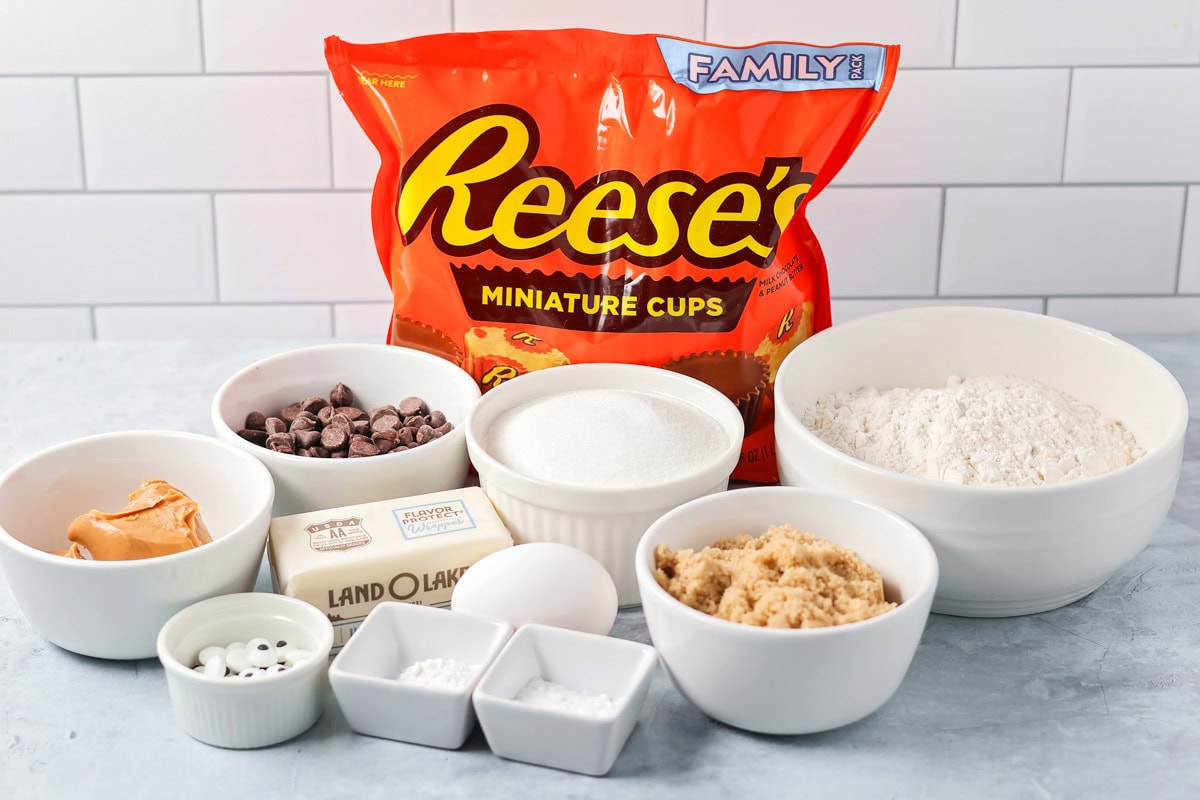 These easy and cute Peanut Butter Spider Cookies are the perfect sweet treat to get you in the spooky spirit. Ingredients to make peanut butter spider cookies on a kitchen counter.