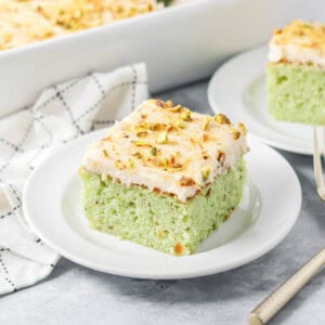 Slice of pistachio cake served on a small plate.