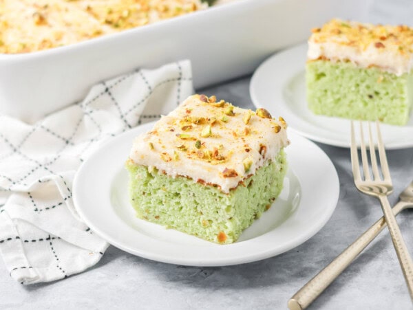 Slice of pistachio cake served on a small plate.