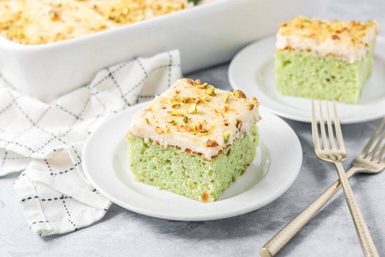 Slice of pistachio cake served on a small plate.