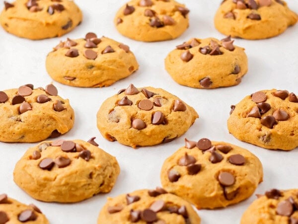 Pumpkin chocolate chip cookies on cookie sheet.