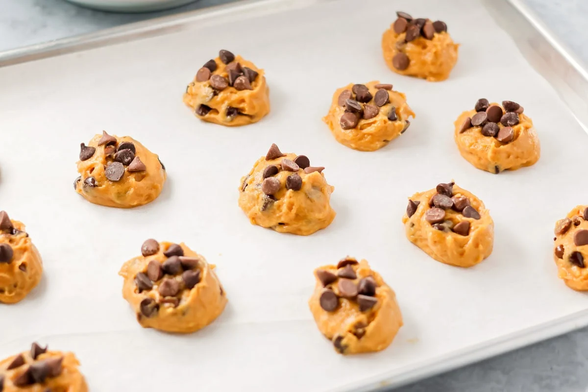 Pumpkin chocolate chip cookies recipe on cookie sheet.