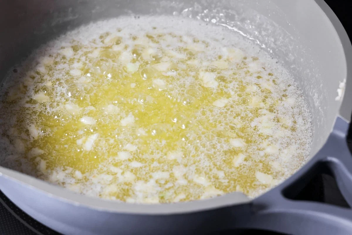 Melting garlic butter sauce in a saucepan.