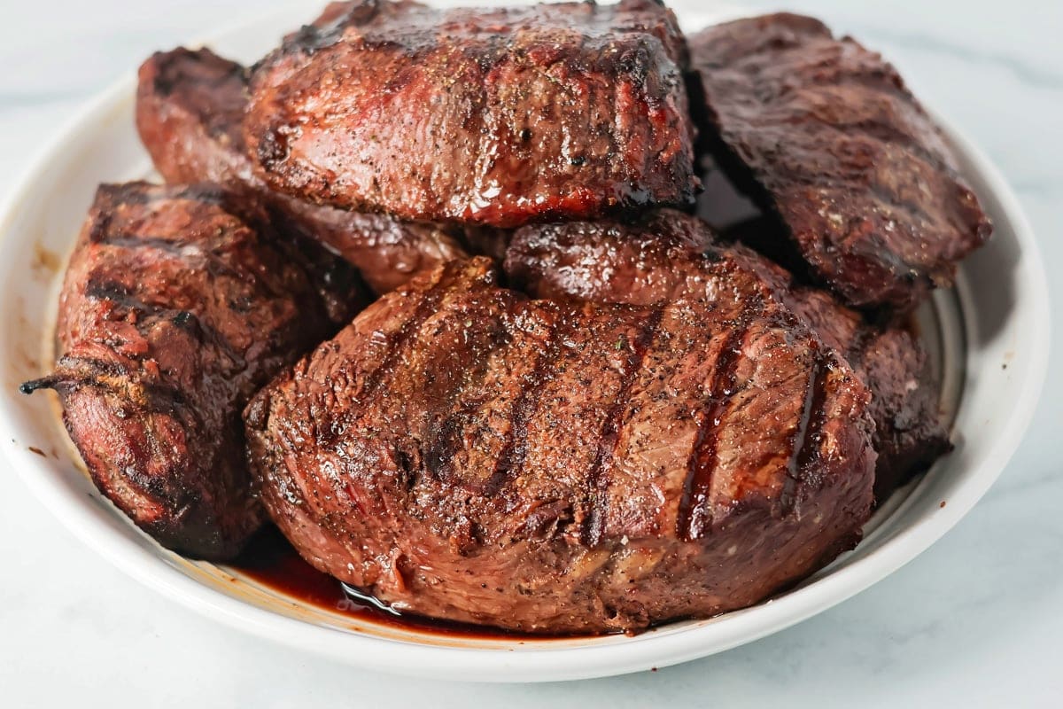 Grilled steak on a serving plate.
