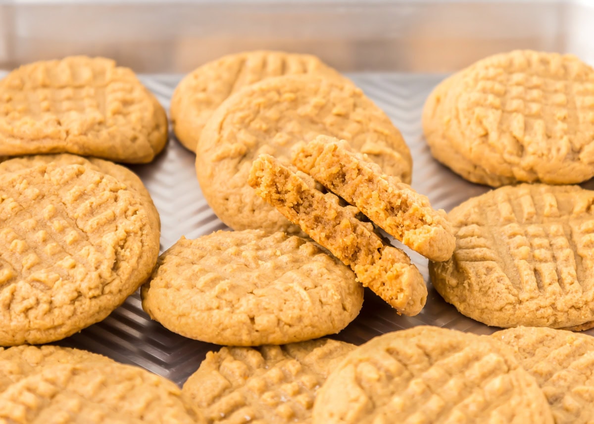 Delicious 3 ingredient peanut butter cookies take just minutes to throw together and are so easy the kids can make them! Baked 3 ingredient peanut butter cookies on a tray.