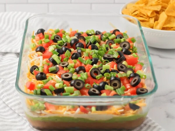 Easy 7 layer bean dip in a glass 9x13 dish.