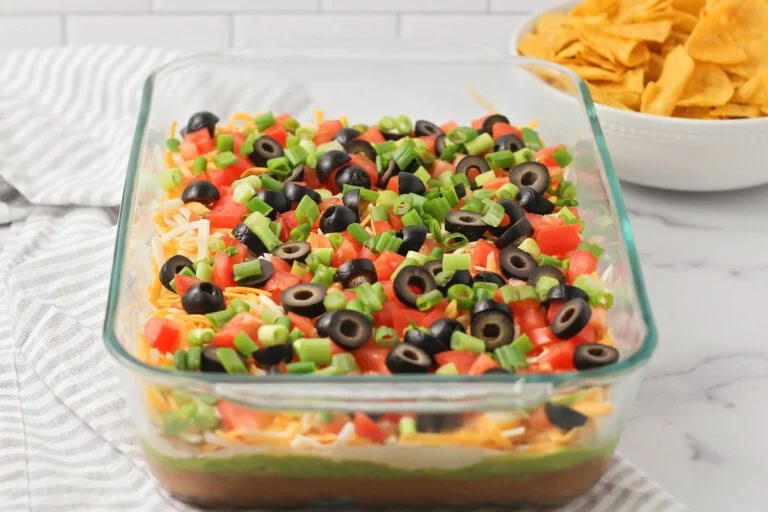 Easy 7 layer bean dip in a glass 9x13 dish.