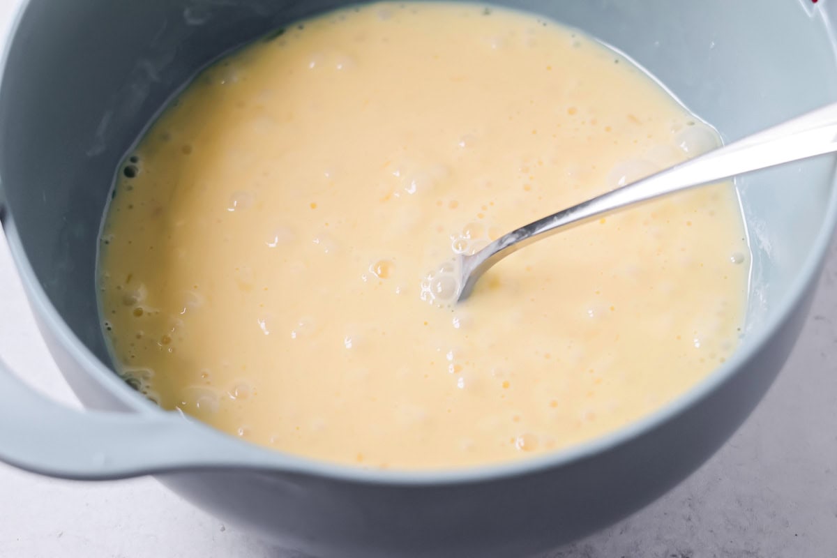 Crispy breakfast quesadillas packed with savory ingredients for a fast family meal that works for breakfast or dinner. Eggs beaten in a bowl.