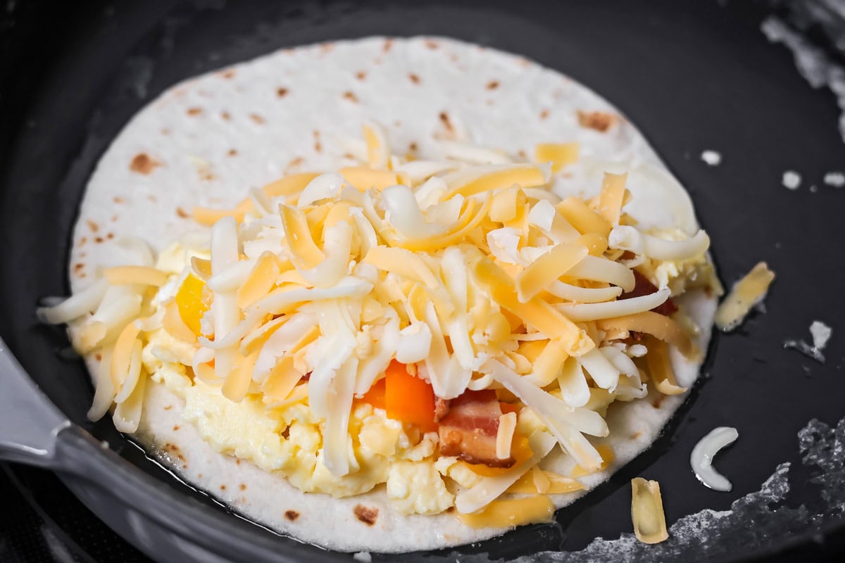 Crispy breakfast quesadillas packed with savory ingredients for a fast family meal that works for breakfast or dinner. Adding quesadilla filling over the eggs