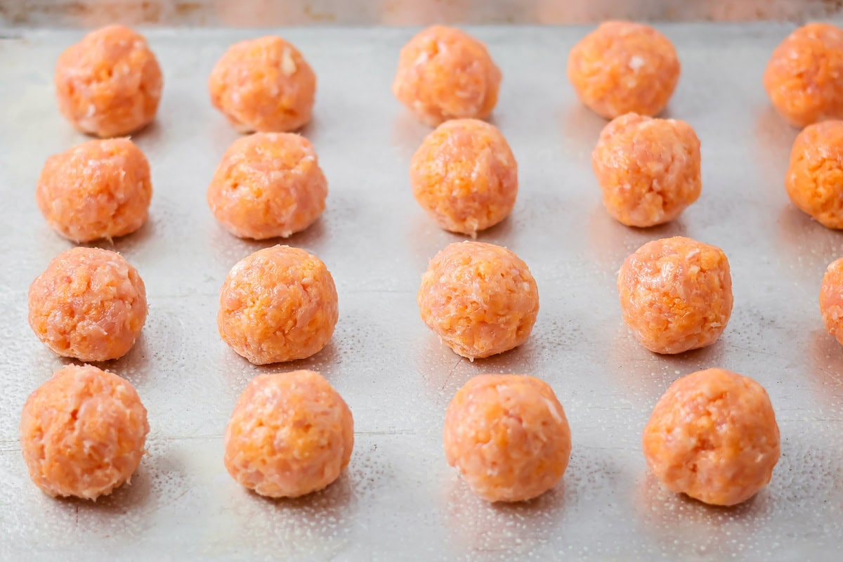Buffalo chicken meatballs on a baking pan.