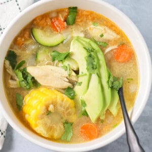 Bowl filled with homemade caldo de pollo soup.