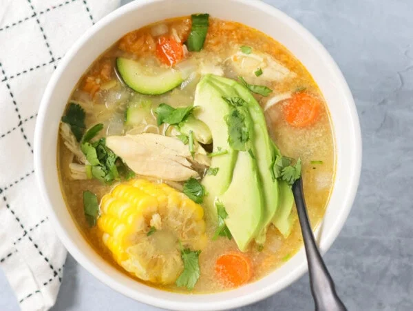 Bowl filled with homemade caldo de pollo soup.
