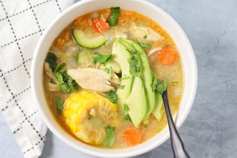 Bowl filled with homemade caldo de pollo soup.
